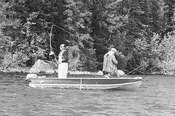 two men on a small boat fishing